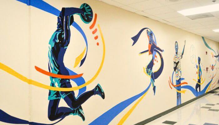School-mural-boy-jumping-with-football
