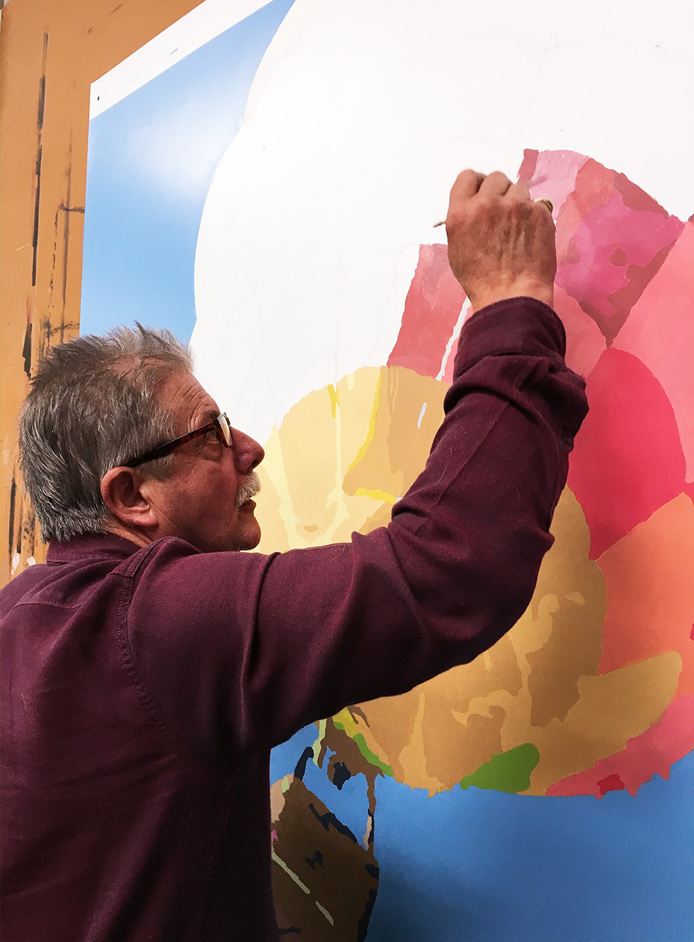 Artist John Espinosa hand painting a mural for Herbert Hoover Middle School in San Jose, CA